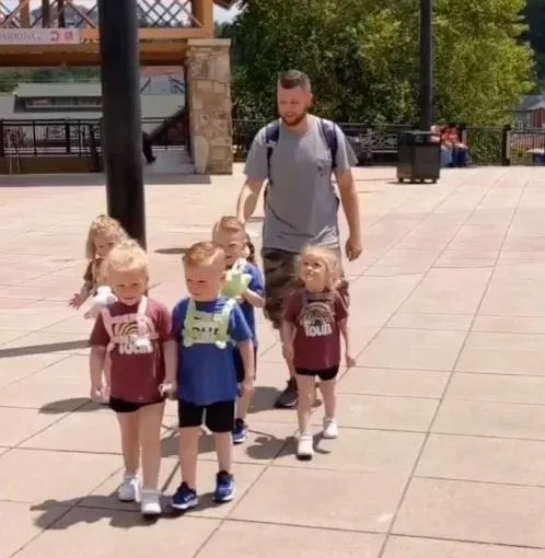 dad uses a leash to take his five-year-old quintuplets for a walk 3378