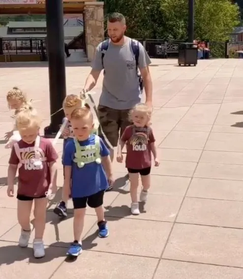 dad uses a leash to take his five-year-old quintuplets for a walk 3379