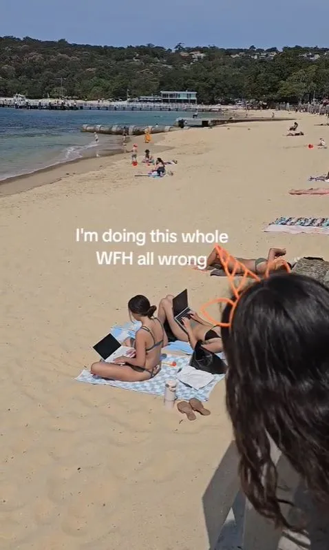 viral video of two women using laptops on a beach reignites the wfh debate 7461