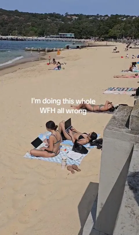 viral video of two women using laptops on a beach reignites the wfh debate 7459