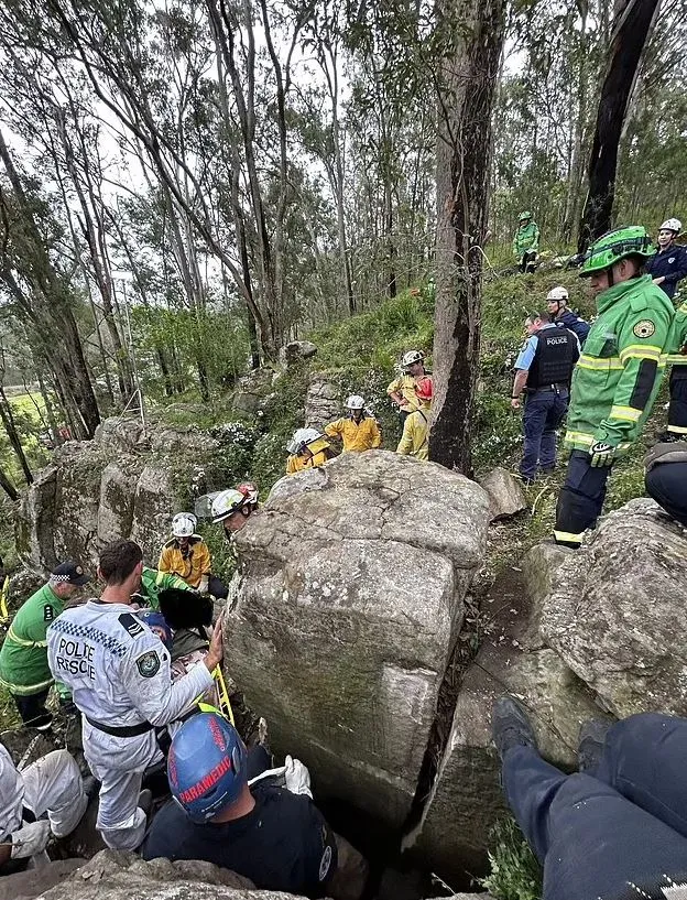 woman stranded upside down between two massive rocks after dropping her iph 8015
