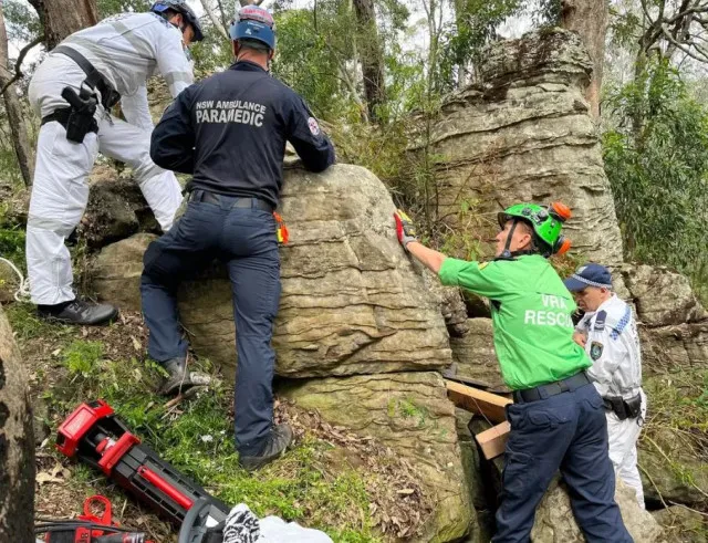 woman stranded upside down between two massive rocks after dropping her iph 8018