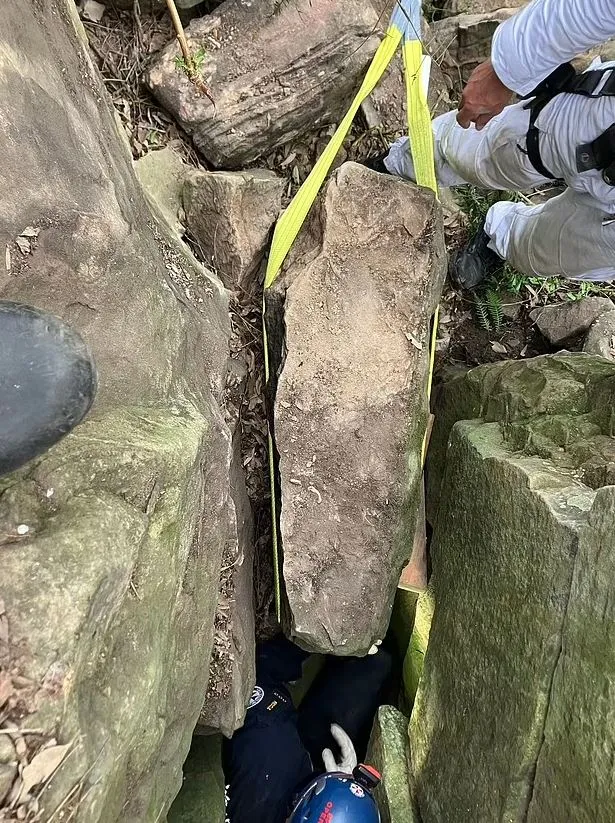 woman stranded upside down between two massive rocks after dropping her iph 8016