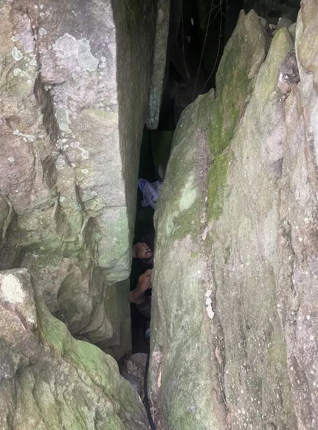 woman stranded upside down between two massive rocks after dropping her iph 8019