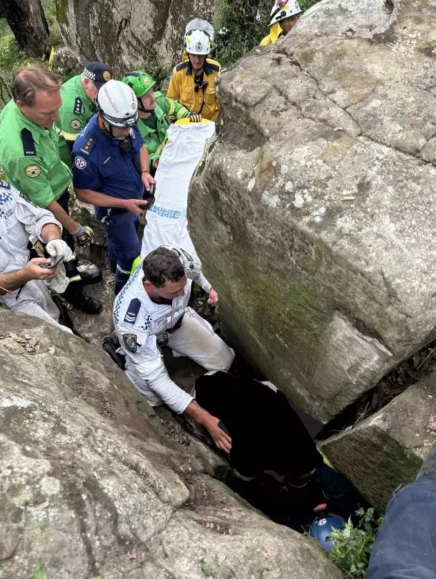 woman stranded upside down between two massive rocks after dropping her iph 8017