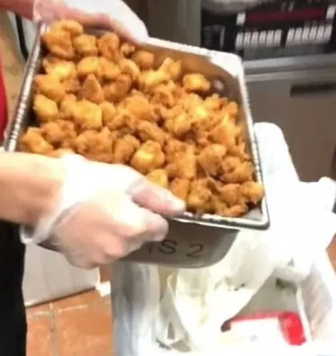 chick-fil-a employee throws away a full tray of chicken nuggets 11076