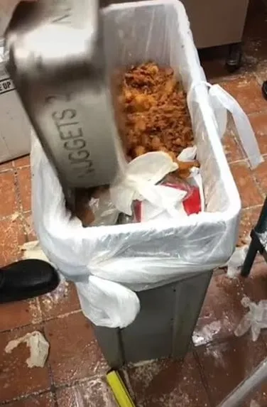 chick-fil-a employee throws away a full tray of chicken nuggets 11077