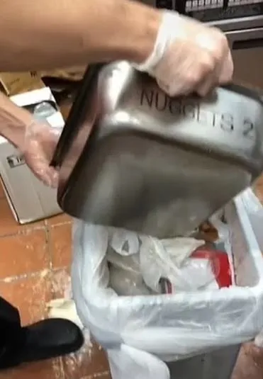 chick-fil-a employee throws away a full tray of chicken nuggets 11078
