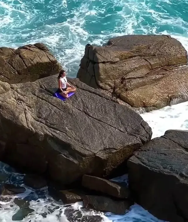 final moments of woman swept to sea while doing yoga on rocks. 11269