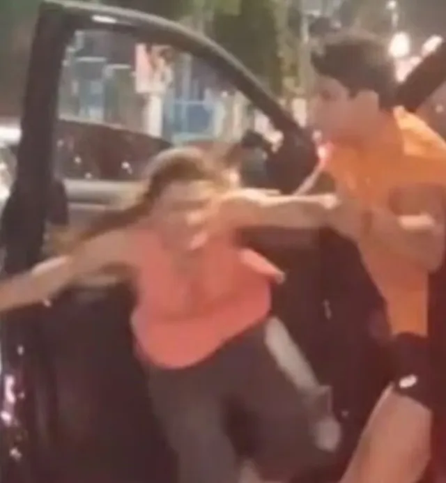 angry wife grabs onto moving pickup truck to hit husband after catching his 11905