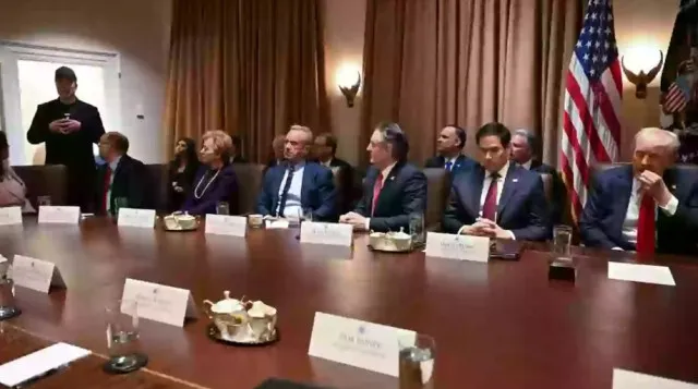 people point out one detail that stands out as donald trump holds his first 18237