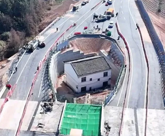 a determined homeowner in china refuses to relocate, forcing construction c 19872