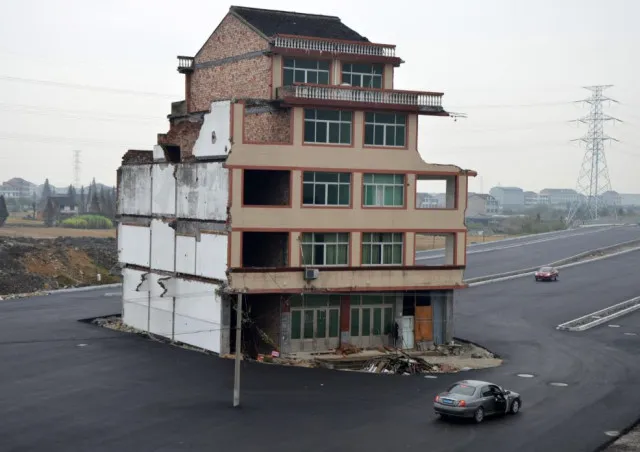 a determined homeowner in china refuses to relocate, forcing construction c 19870