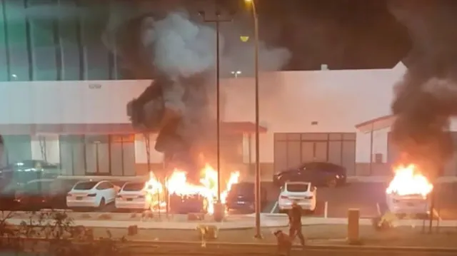 man arrested in molotov cocktail attack on tesla dealership also faces fede 20688